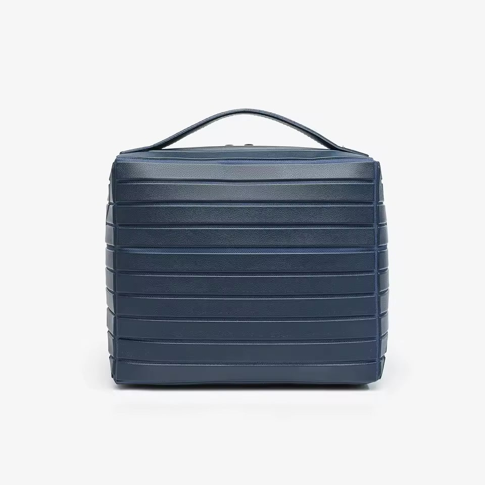 The Compackt Traveller — folded flat and packed inside carry-on luggage