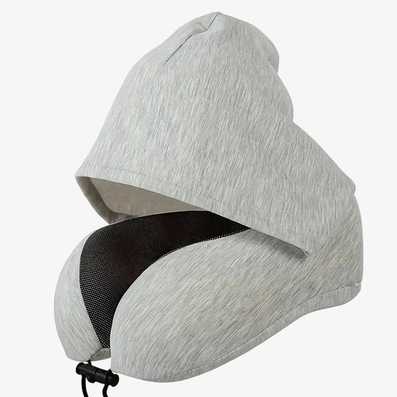 The Packt Pillow — compressed and clipped to carry-on luggage handle