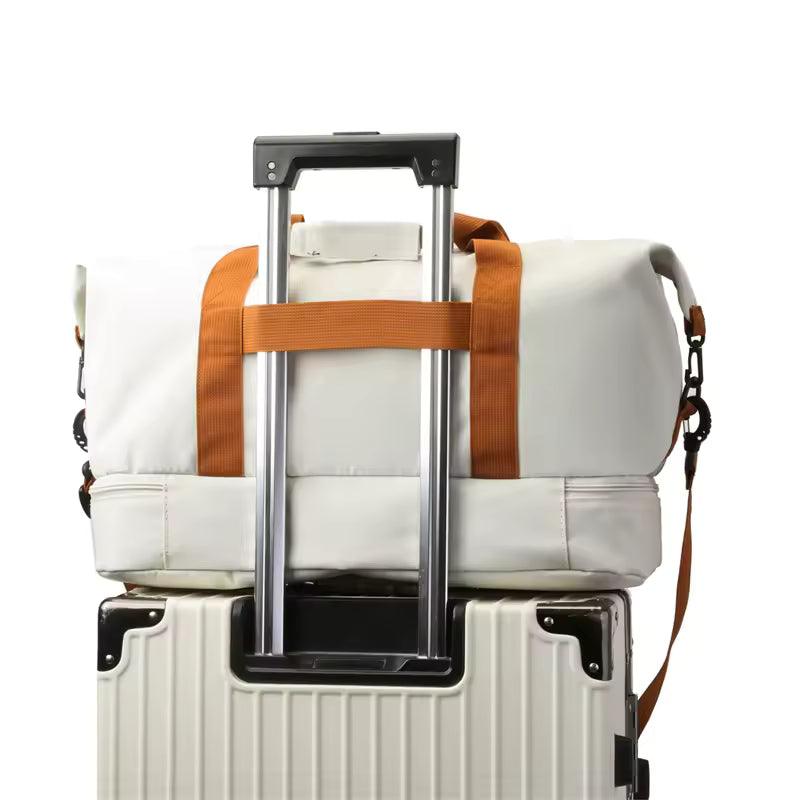 The Packt Weekender duffel riding a rolling suitcase — luggage pass-through slipped over the trolley handle