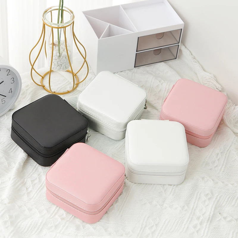 The Packt Jewels travel jewelry organizer — open view showing multi-compartment interior with ring rolls and earring holders