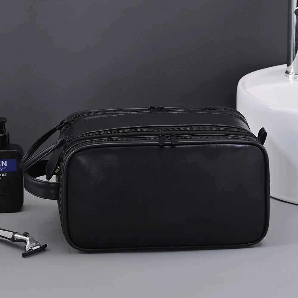 The Packt Kit carried by the side handle — compact travel toiletry bag