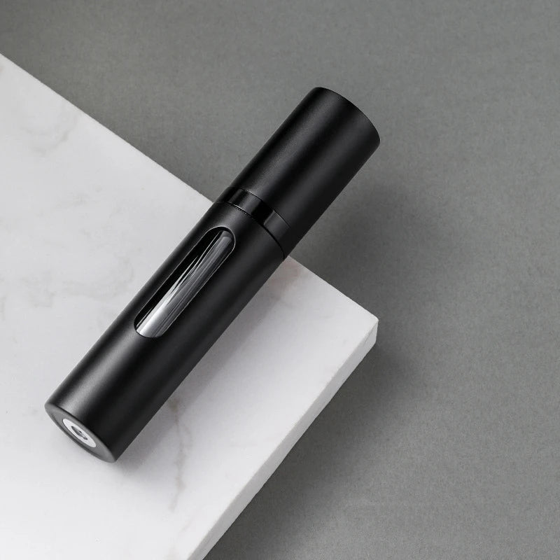 The Packt Atomizer — lifestyle shot showing atomizer inside carry-on alongside The Packt Traveller