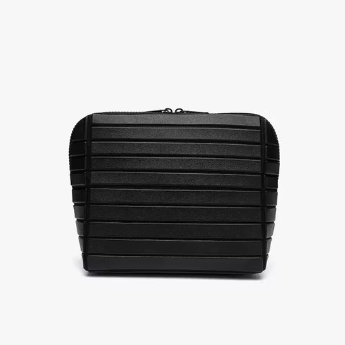The Packt Traveller toiletry bag in Black — front view showing ribbed exterior and double zipper