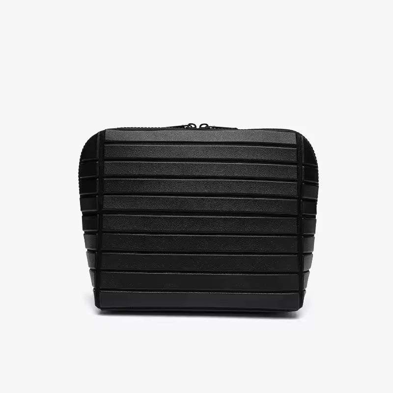The Packt Traveller toiletry bag in Black — front view showing ribbed exterior and double zipper