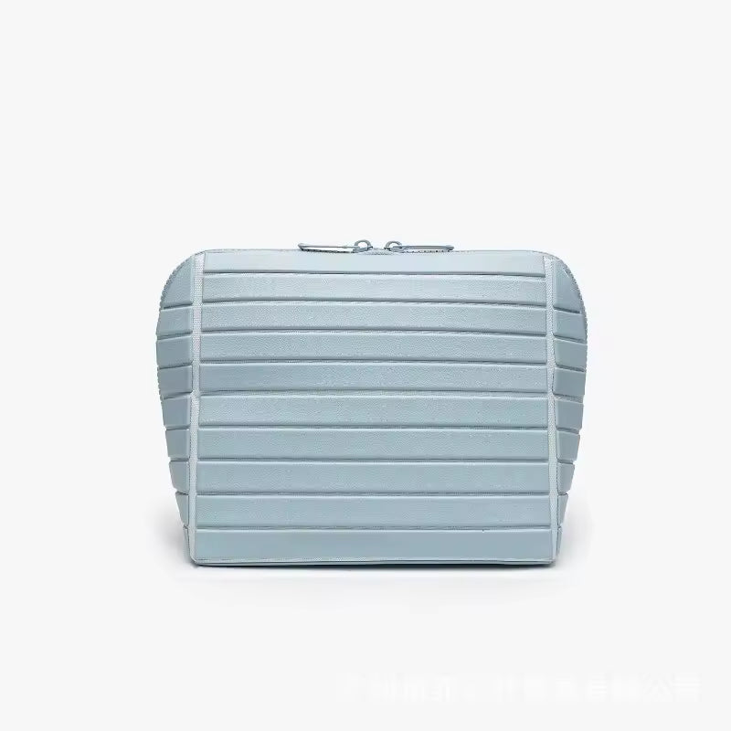The Packt Traveller toiletry bag in Blue — front view showing ribbed exterior and double zipper
