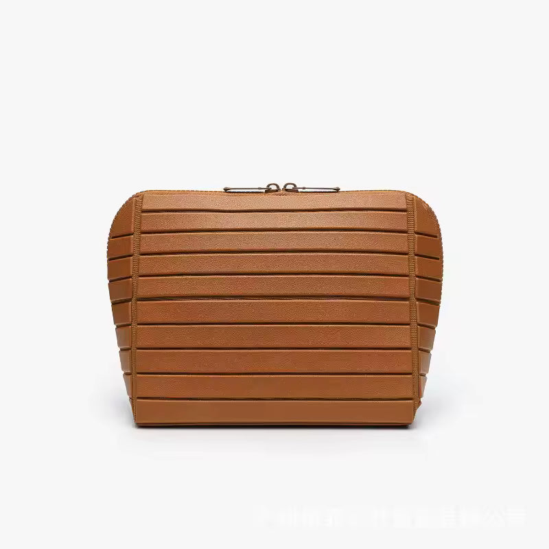 The Packt Traveller toiletry bag in Brown — front view showing ribbed exterior and double zipper
